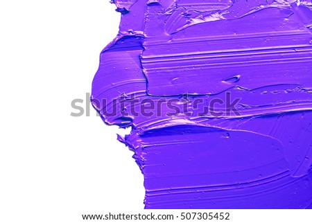 purple  brush strokes of oil paint on the white palette