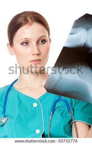 Pretty female doctor looking at the xray picture