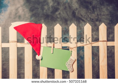 Empty greeting Christmas card on wooden fence. Christmas theme