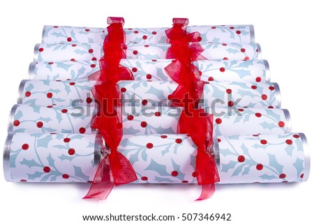 A studio shot of Christmas Crackers or otherwise known as Bon Bons.  A cracker consists of a cardboard tube wrapped in a brightly decorated twist of paper with a gift in the central chamber.