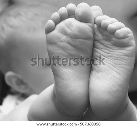 small child foot closeup / black and white photo in a retro style