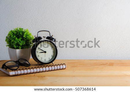 alarm clock and home decor on brick wall background