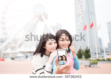 two beauty woman thumb up and selfie in hongkong