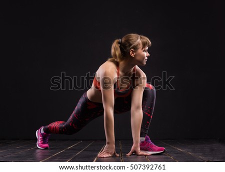 Sport woman posing in photostudio. Fitness motivation picture on dark background
