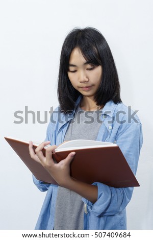 asian cute girl reading a book with wall white background