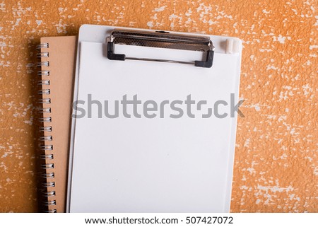 clipboard with blank paper on  wood table