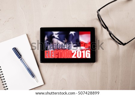 tablet with American flag on wooden table, glasses, pen and Notepad, promotion of popular elections in the United States