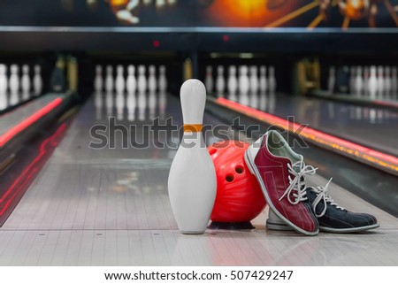 bowling shoes and ball for bowling game on the background of the playing field