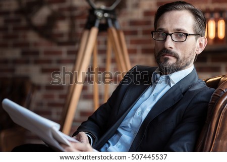 Serious successful businessman holding some documents Royalty-Free Stock Photo #507445537