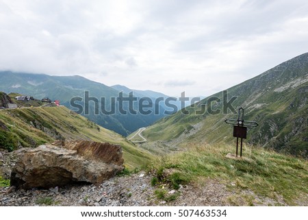 View to the carpathian mountains war road transfagarasan from the top with lonely trees and clouds above