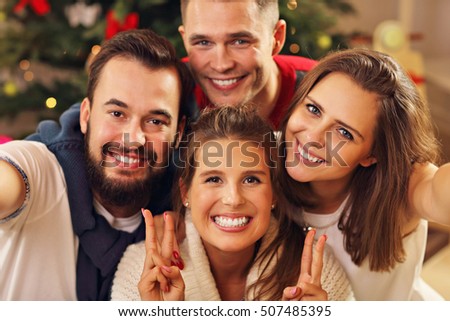 Picture showing group of friends taking selfie during Christmas