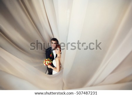 Young couple  look great on a background of white fabric