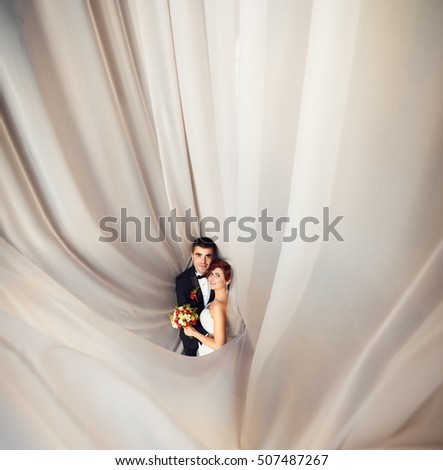 Creative couple in love posing for photographer