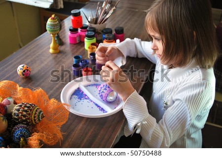 schoolgirl is make wickerwork of beads and eggs