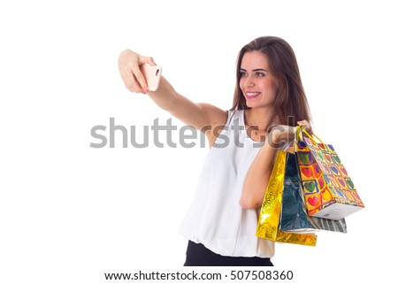 Woman with shopping bags making selfie