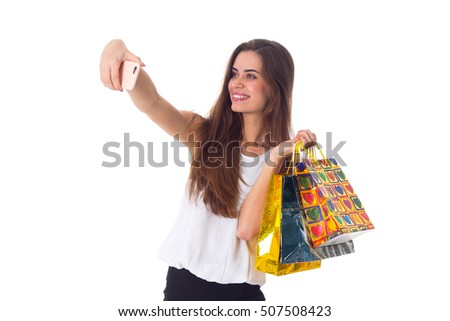 Woman with shopping bags making selfie