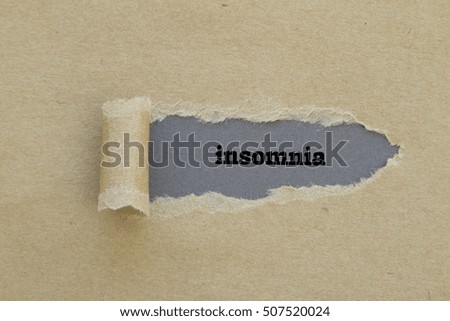 Insomnia word written under torn paper.