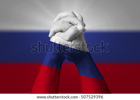 Man clasped hands patterned with the RUSSIA flag