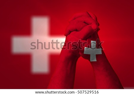 Man clasped hands patterned with the SWITZERLAND flag