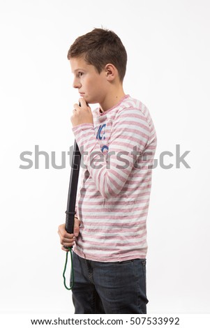 Actor brunette boy in a pink jumper with a baton on a white background