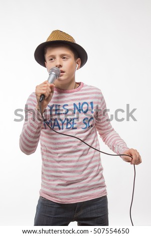 singer brunette boy in a pink jersey in gold hat with a microphone on a white background