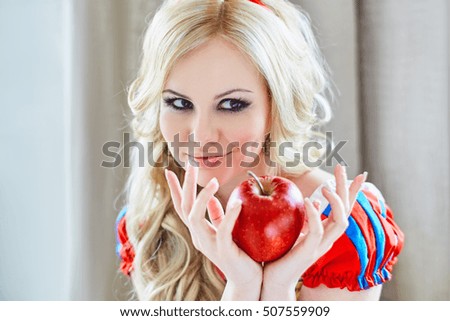 Positive woman holding an apple