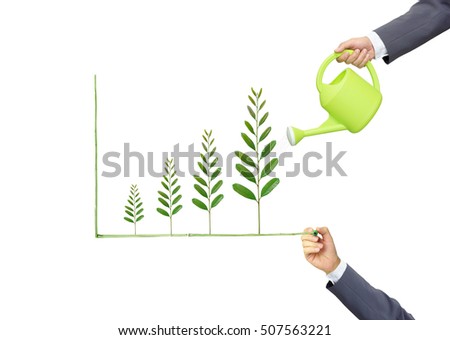 Businessmen watering and writing green tree leaves arranged as a growing graph / csr / sustainable development / corporate social responsibility