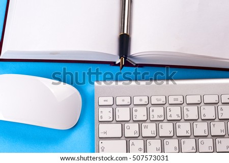 Office desk table with computer, books, a magnifying glass and pen. Top view with copy space. Corporate stationery branding mock-up