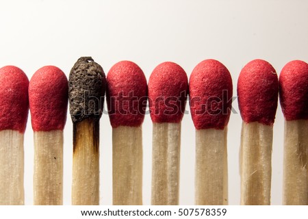 Clean matches around a burnt one. Royalty-Free Stock Photo #507578359