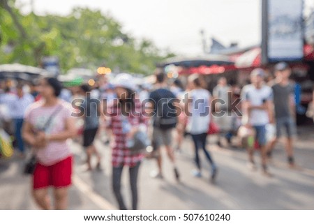 Abstract blur tourist shopping in Chatuchak weekend market outdoor in sunny day Bangkok Thailand background
