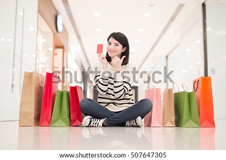 happy shopping young woman show credit card,sit on the floor in the honkong, asian