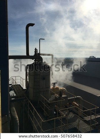 process water steam of power plant boiler mill system on blue sky cloud background