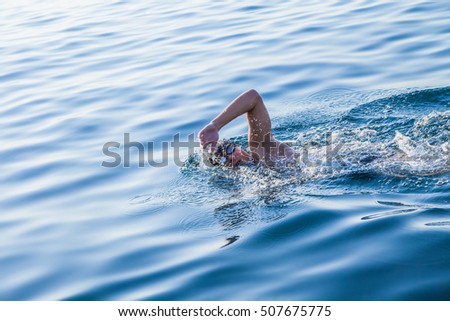 Man swimming in clear water