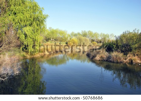 Tranquil river landscape with reflection in the water