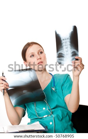Young female doctor looking at the xray pictures