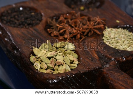 Indian spices arranged on a wooden background Kerala, India. For adding flavor and aroma to food.