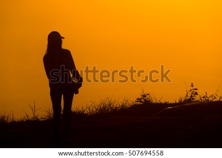 Photographer woman silhouette and sunrise