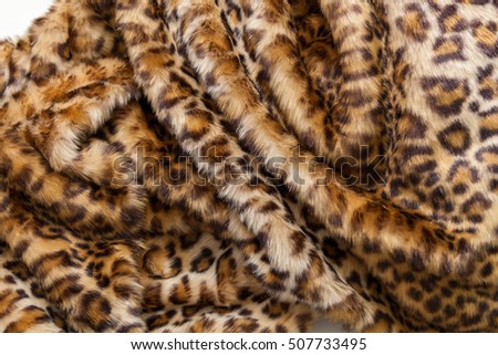 Leopard fur textile. The folds of the leopard fur textile close up.