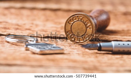 Notary public wax stamper on old wooden background Royalty-Free Stock Photo #507739441