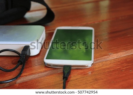 smart phone charge power bank on wooden table