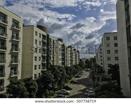 Perspective view modern Condominium or Apartment building. Architecture in big city downtown. Green garden. car park. Blue sky cloud