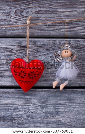 Traditional New Year's toys. Christmas holidays. Beautiful little fairy and red wooden heart. 