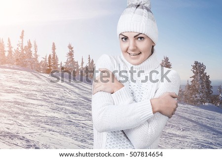 Beautiful woman in the winter snowy scenery.