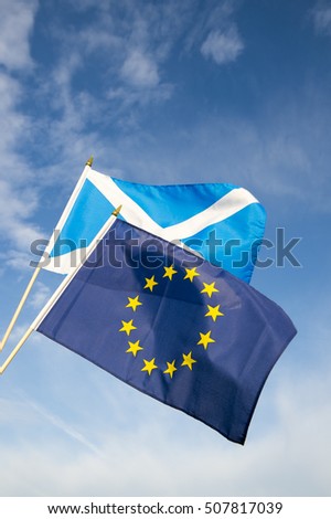 Scottish and EU flags flying in bright blue sky