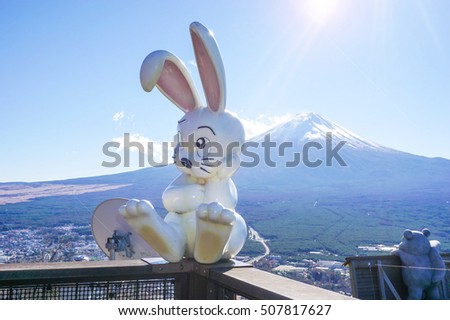 Rabbit seated with the background of Fuji Mountain and sunlight Royalty-Free Stock Photo #507817627
