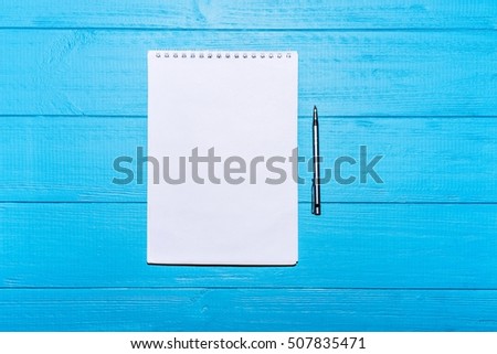 Flat layout. Blank notebook on a blue wooden background