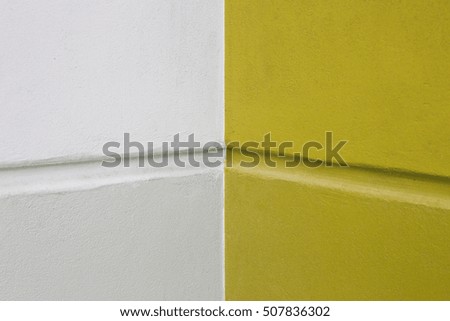 yellow and white painted on cement wall