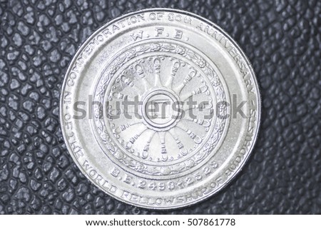 thai baht coin on black leather background