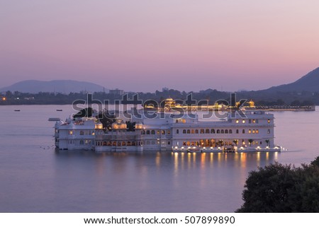 This photo was shot from Udaipur city at twilight time. Udaipur city palace was built over a period of nearly 400 years being contributed by several kings of the dynasty.  Focus at palace building. Royalty-Free Stock Photo #507899890