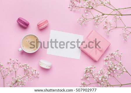 Morning cup of coffee, cake macaron, gift or present box and flower on pink table from above. Beautiful breakfast. Flat lay style. Royalty-Free Stock Photo #507902977
